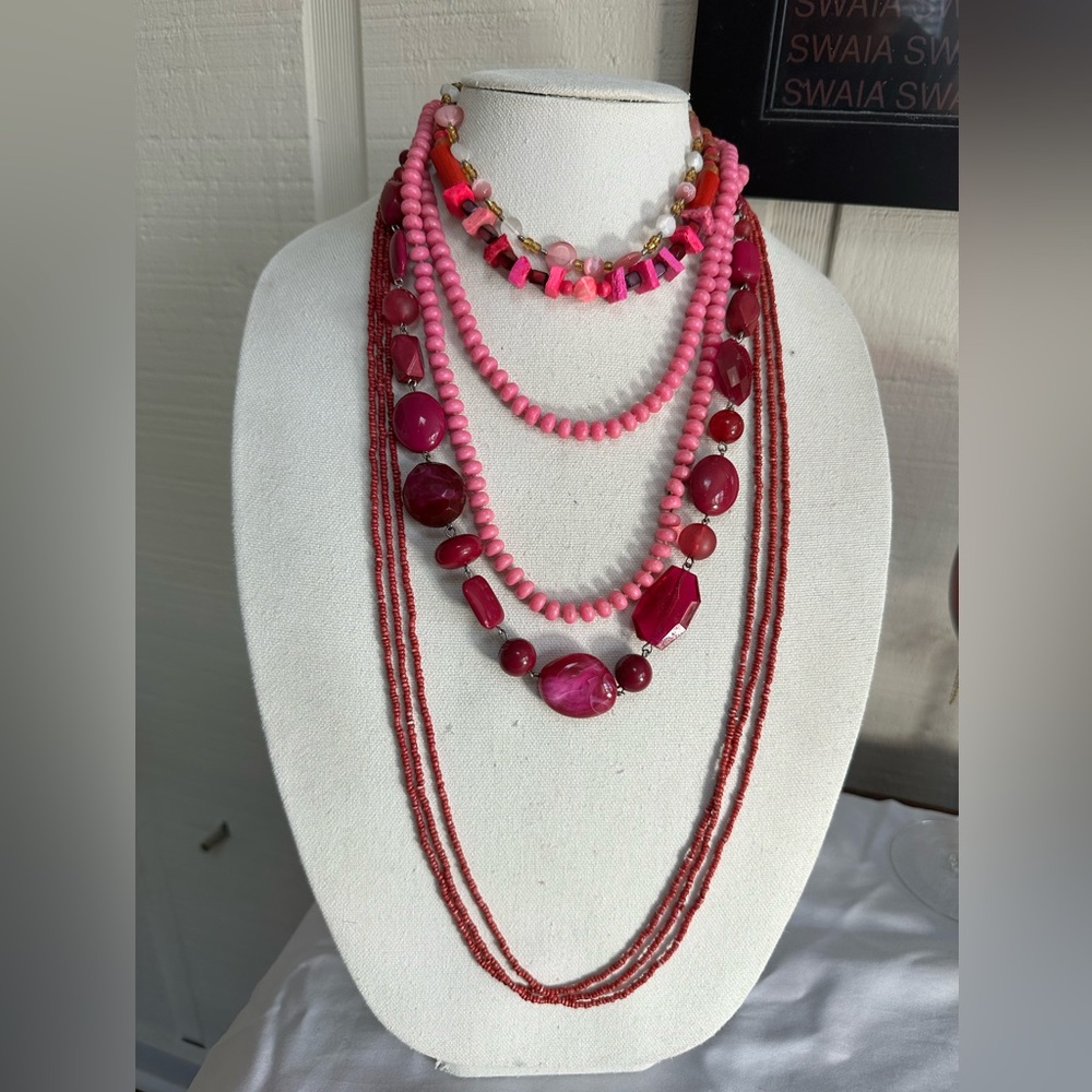 Five pink vibe necklaces and bracelets